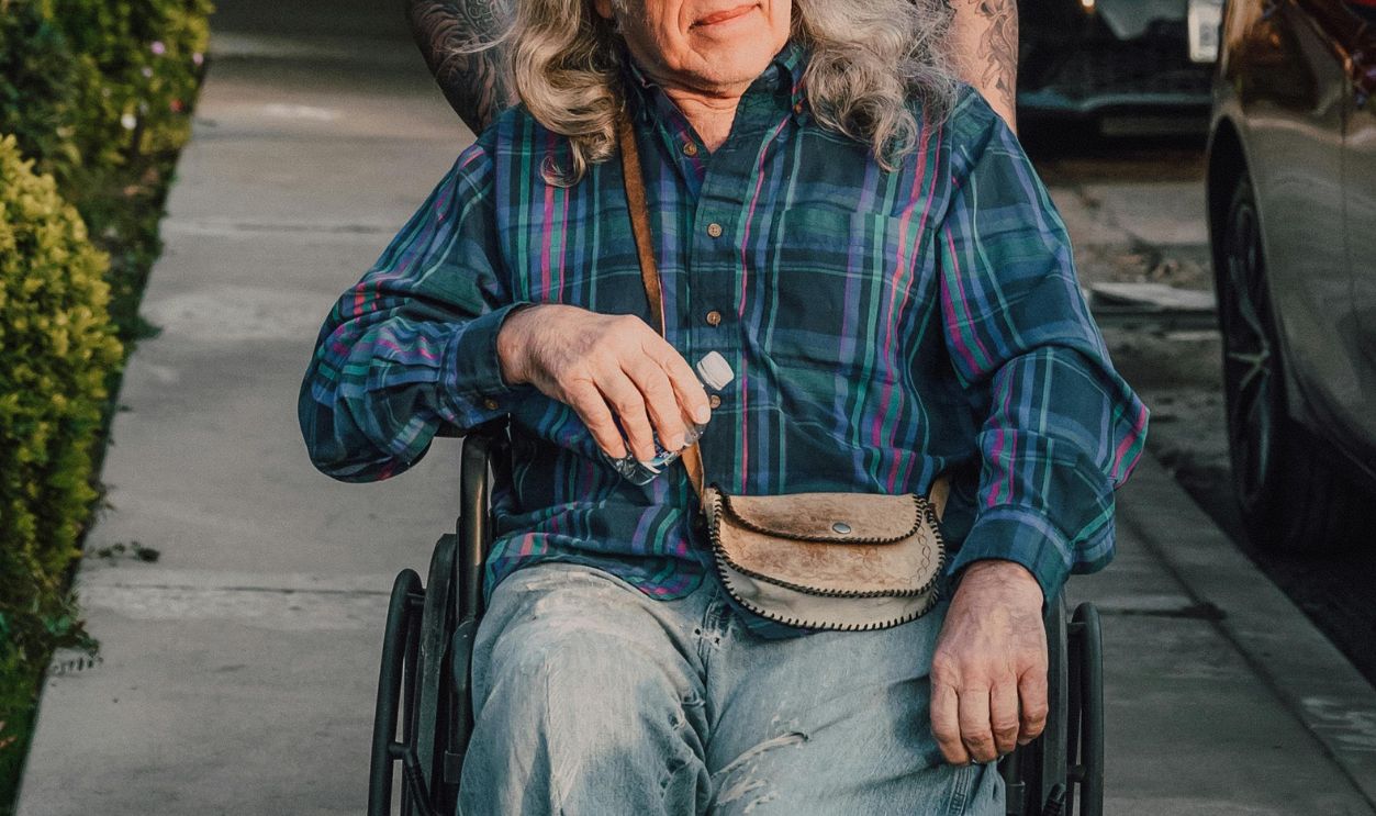 A Man Pushing an Elderly on a Wheelchair