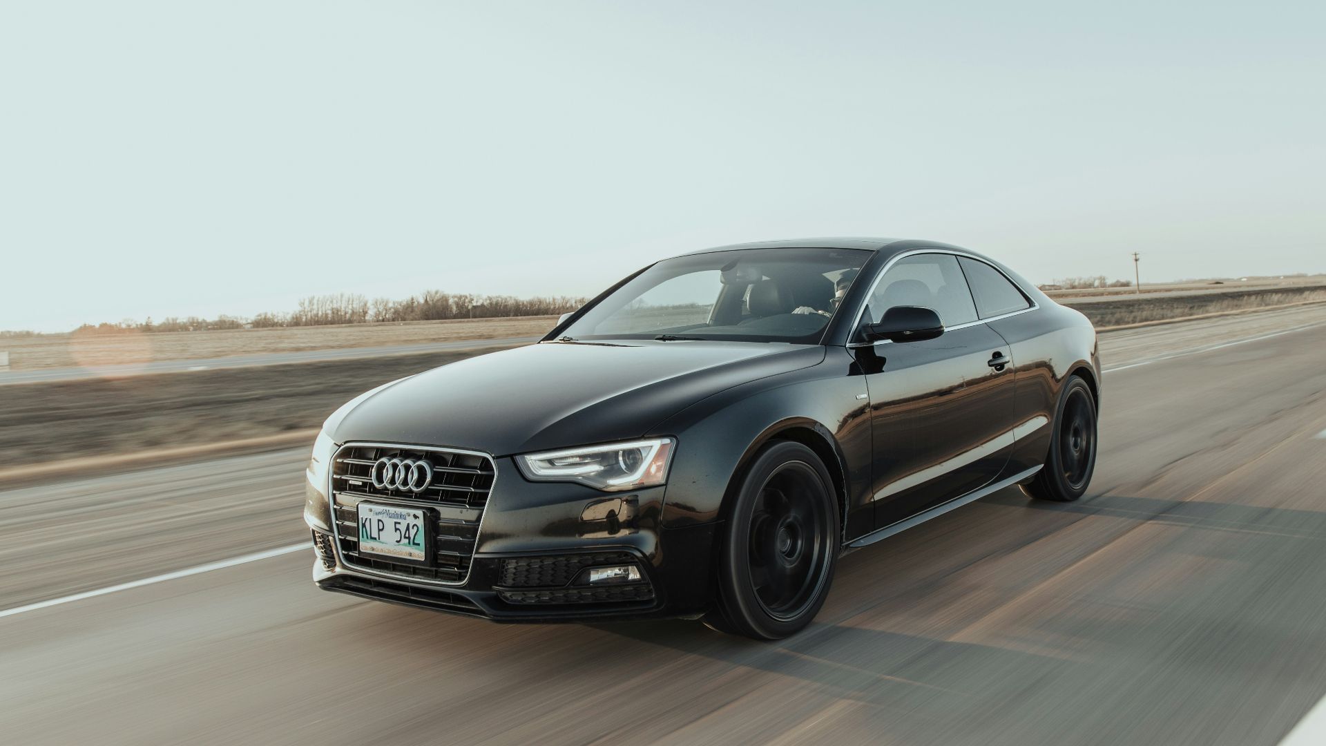 black audi sedan on road during daytime