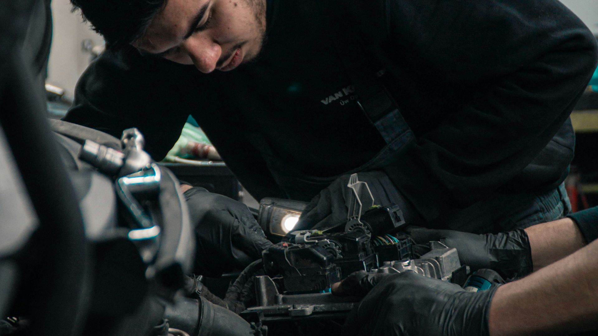 man in black jacket and blue denim jeans riding motorcycle