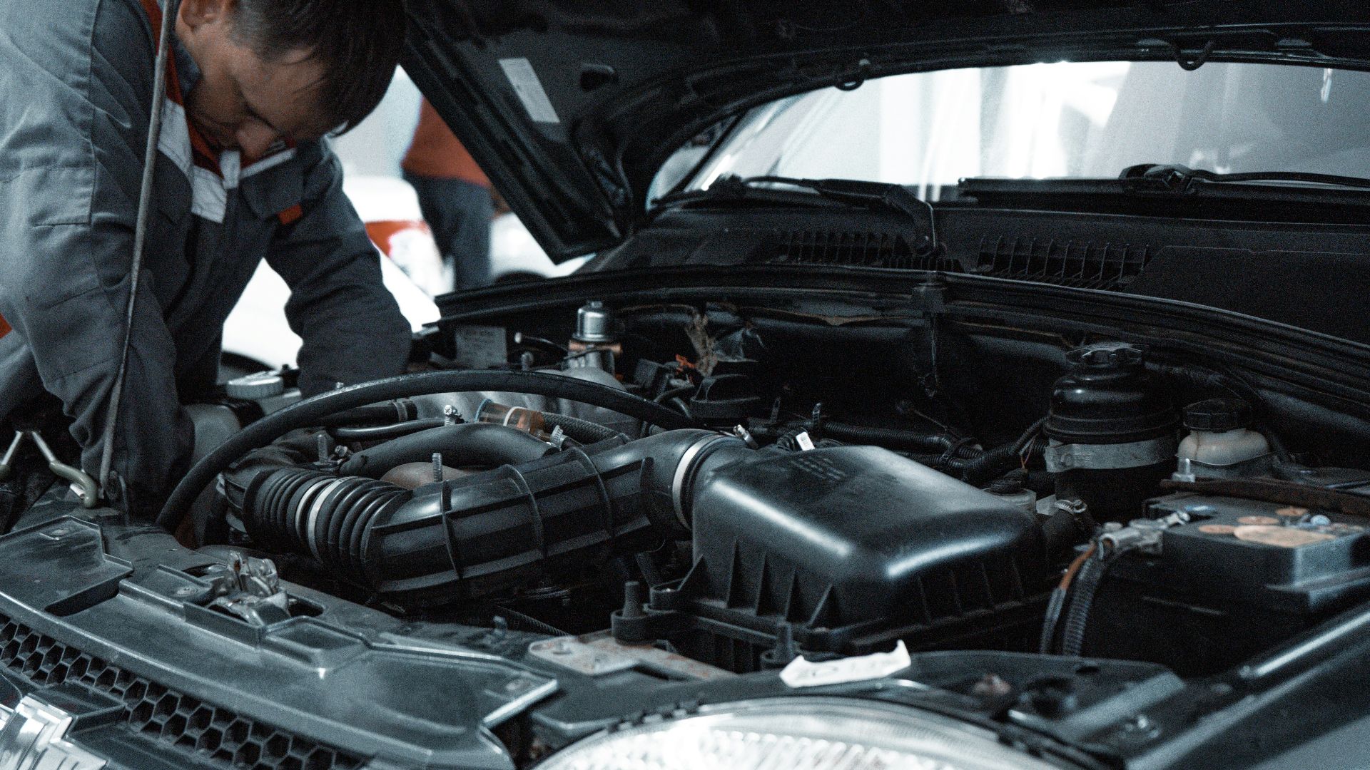 man in white shirt standing beside black car