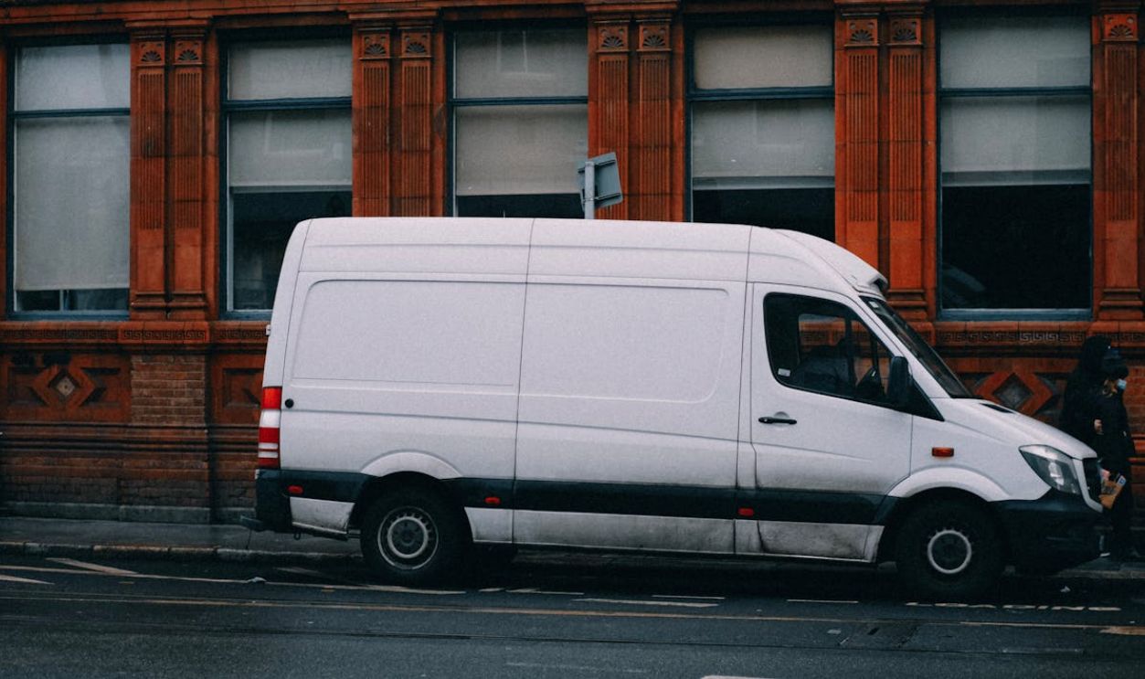 A White Van Parked on the Side of the Road
