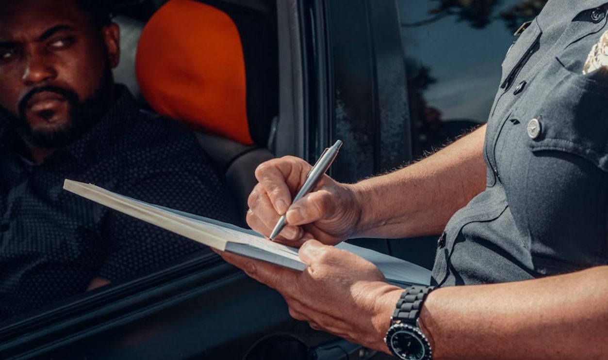 A Police Officer Signing the Traffic Ticket