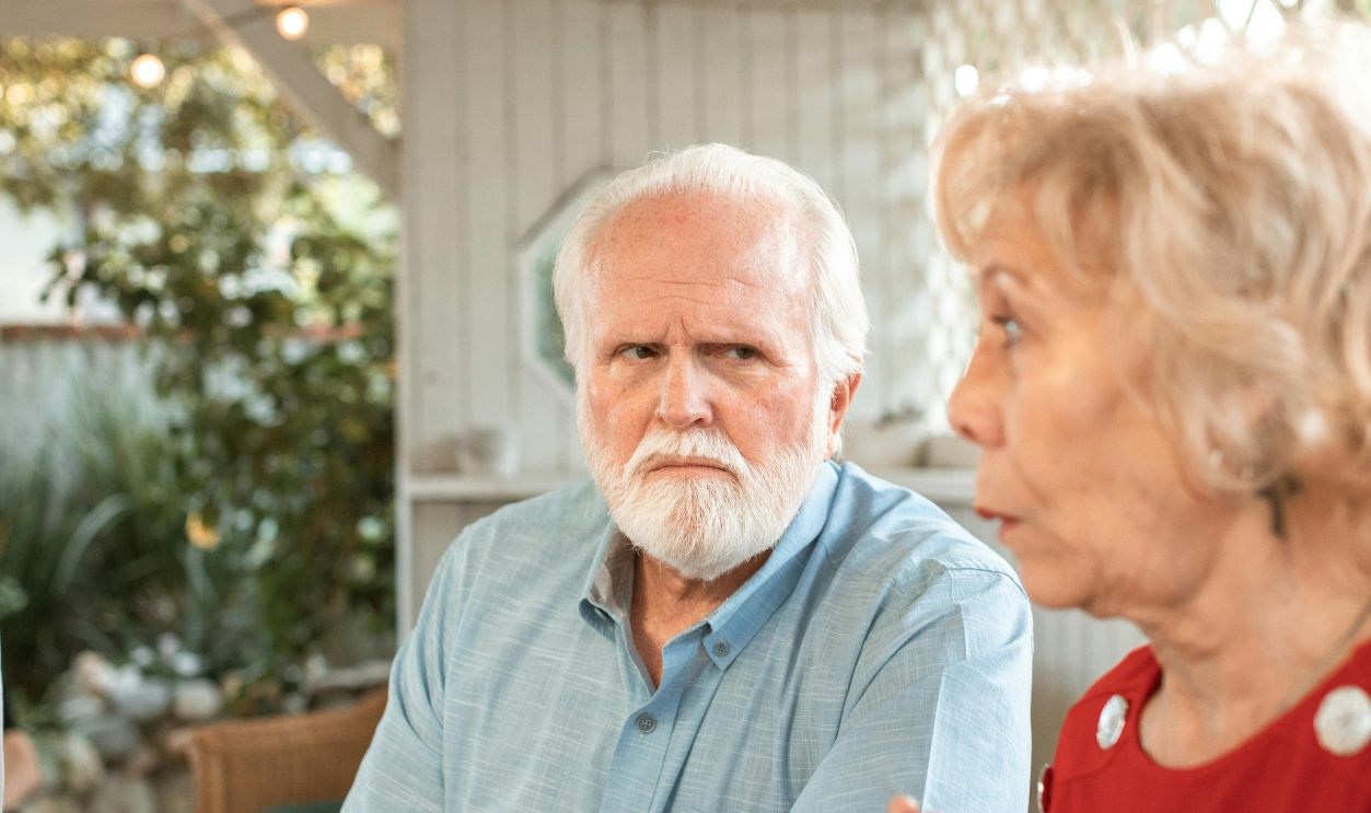 Elderly Man Sitting Beside His Wife