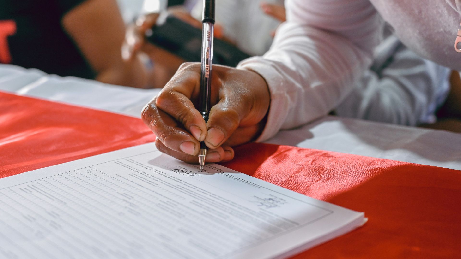 a person writing on a piece of paper