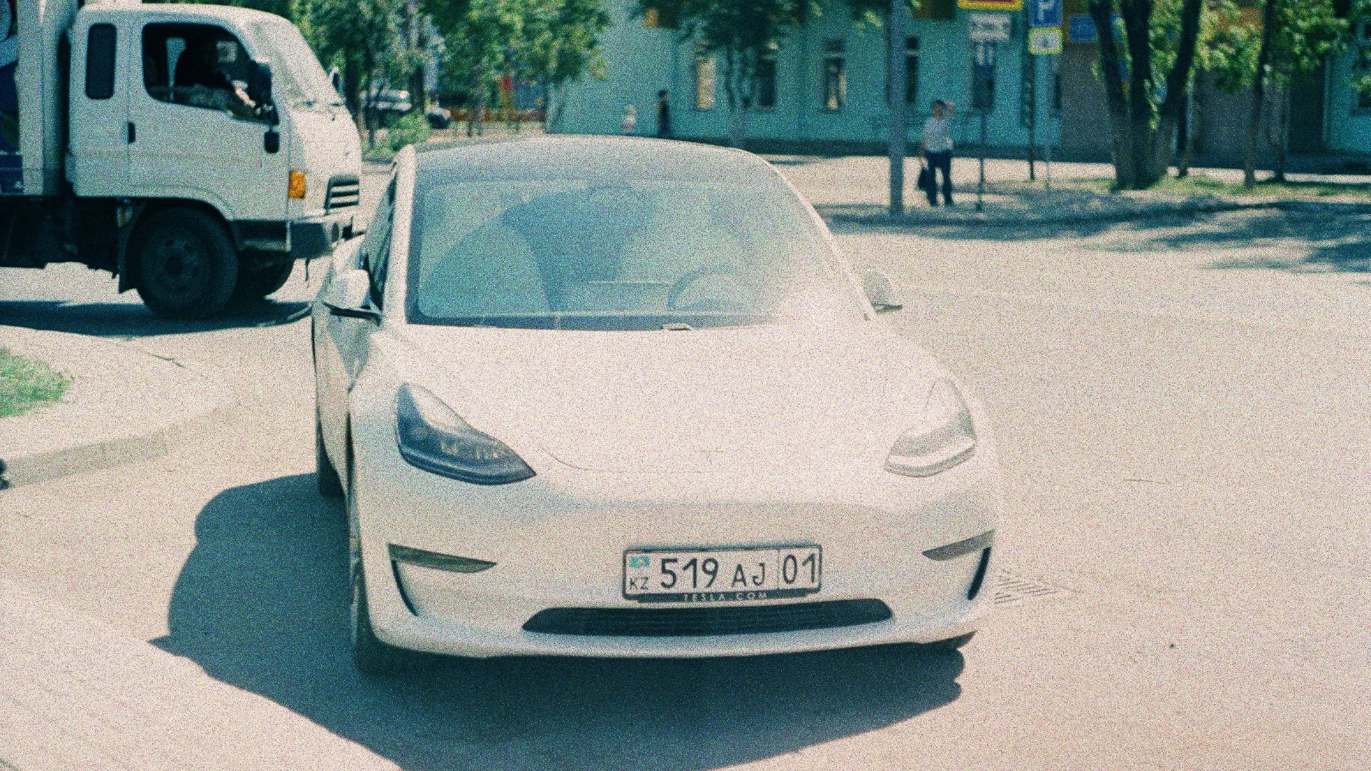 a white car parked on the side of the road