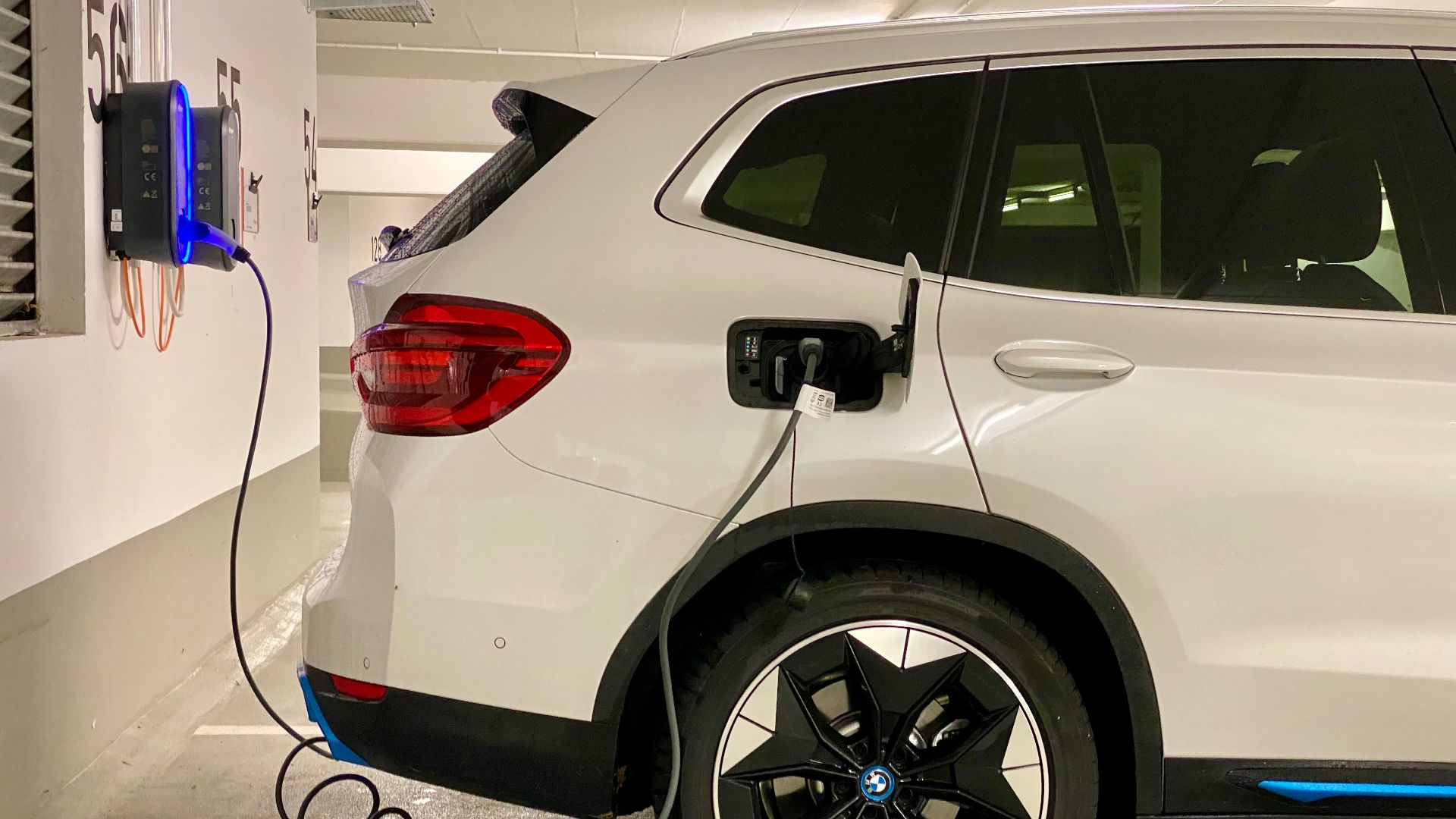 an electric car plugged in to a charging station