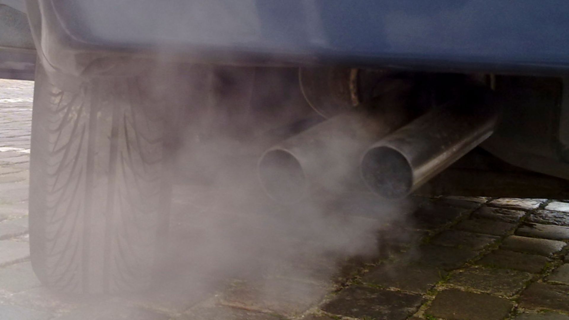 Automobile exhaust gas. White exhaust gas is mostly water vapor. Black smoke could come from oil burning.