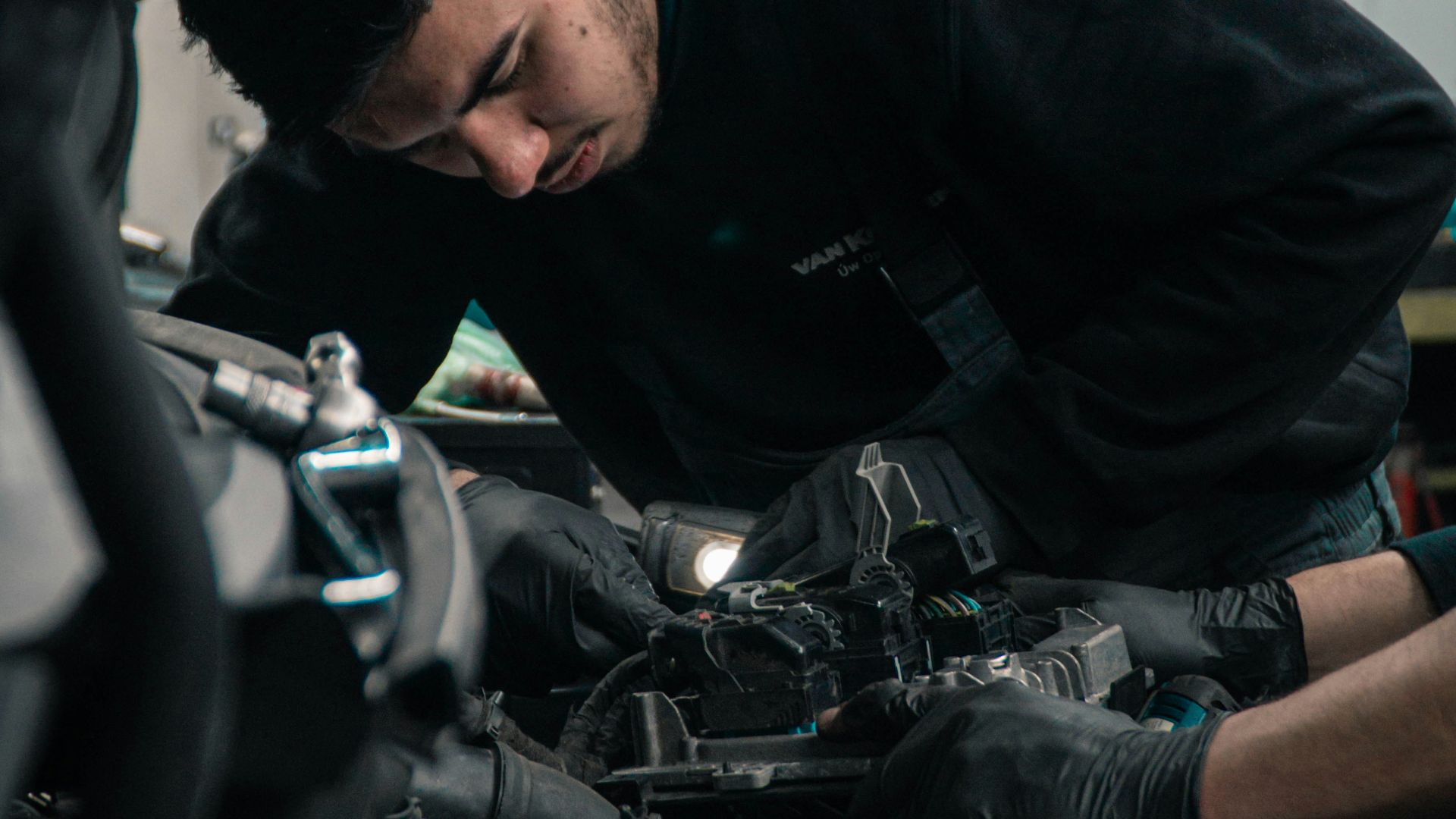man in black jacket and blue denim jeans riding motorcycle