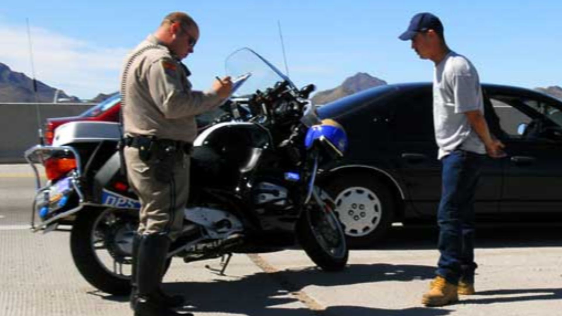 A motor officer writes a traffic ticket for a motorist caught speeding

Photo © by Jeff Dean