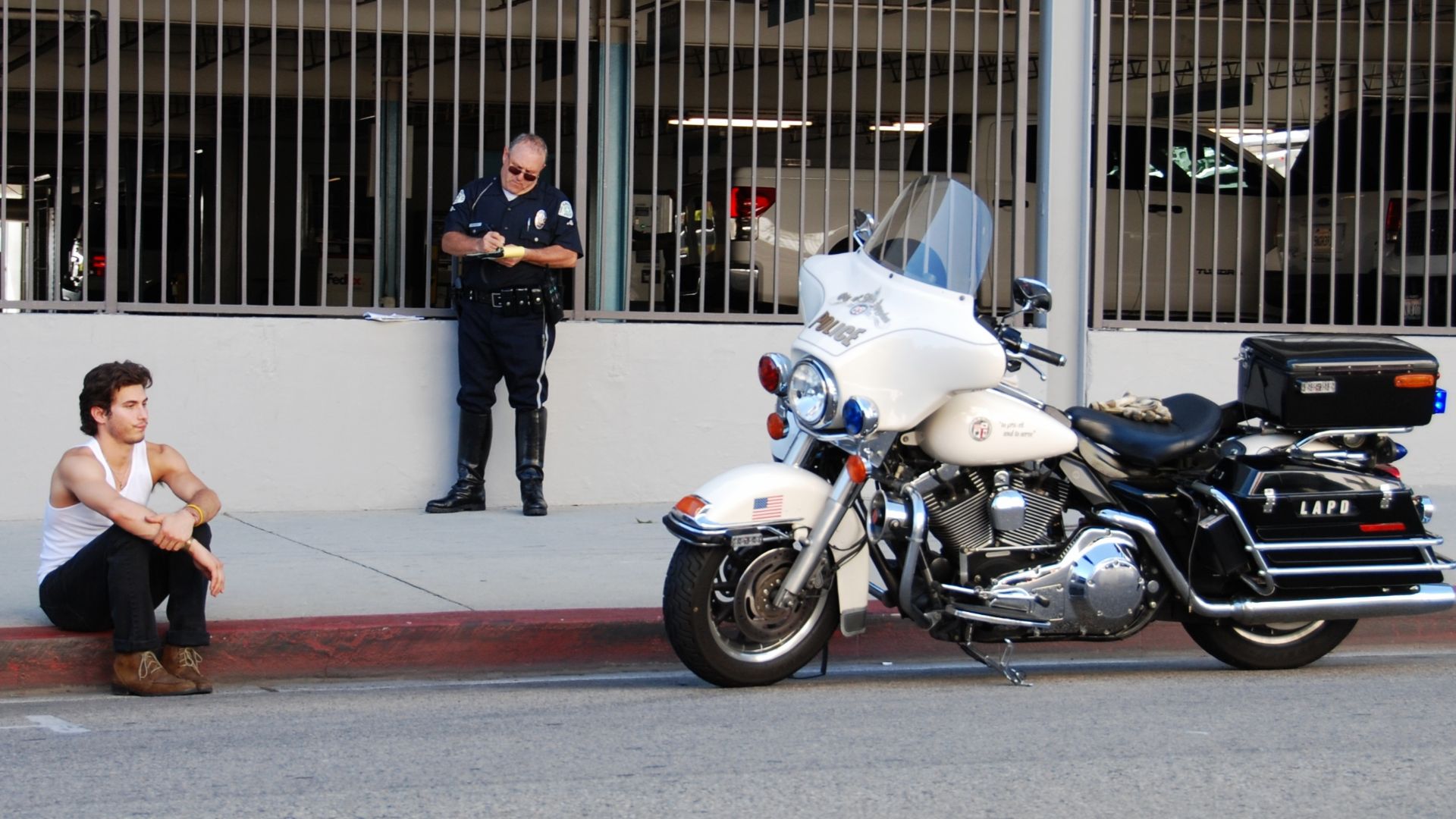 An LAPD motorcycle officer issuing a motorist a traffic ticket in Hollywood, California.