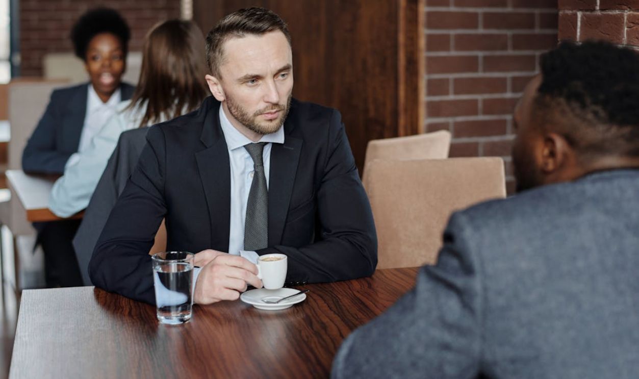 Businessmen Having a Meeting at a Cafe