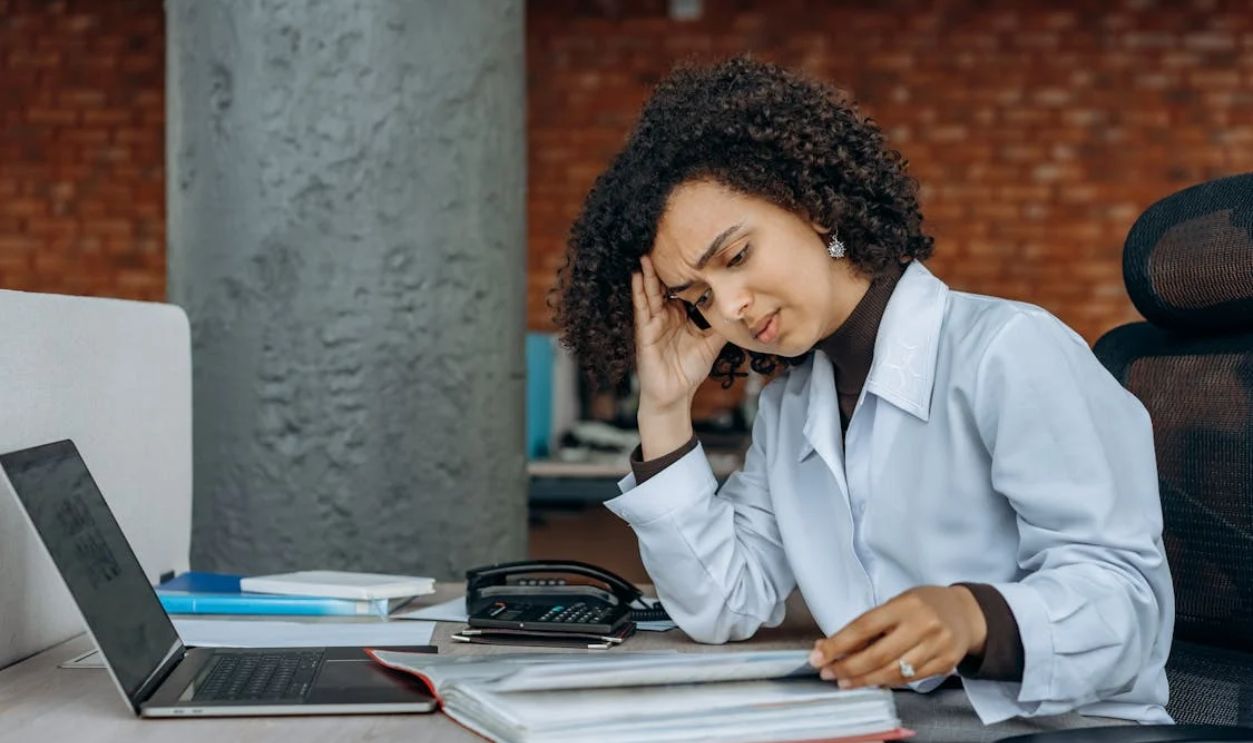An Exhausted Woman Reading Documents