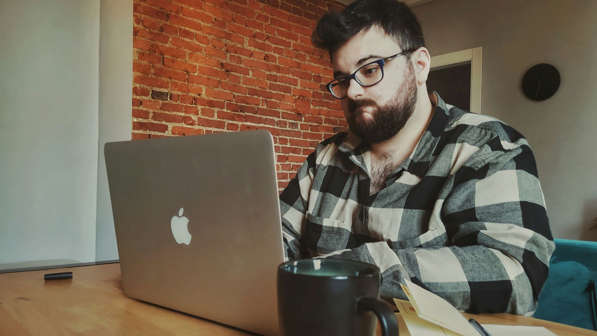 a man sitting in front of a laptop computer