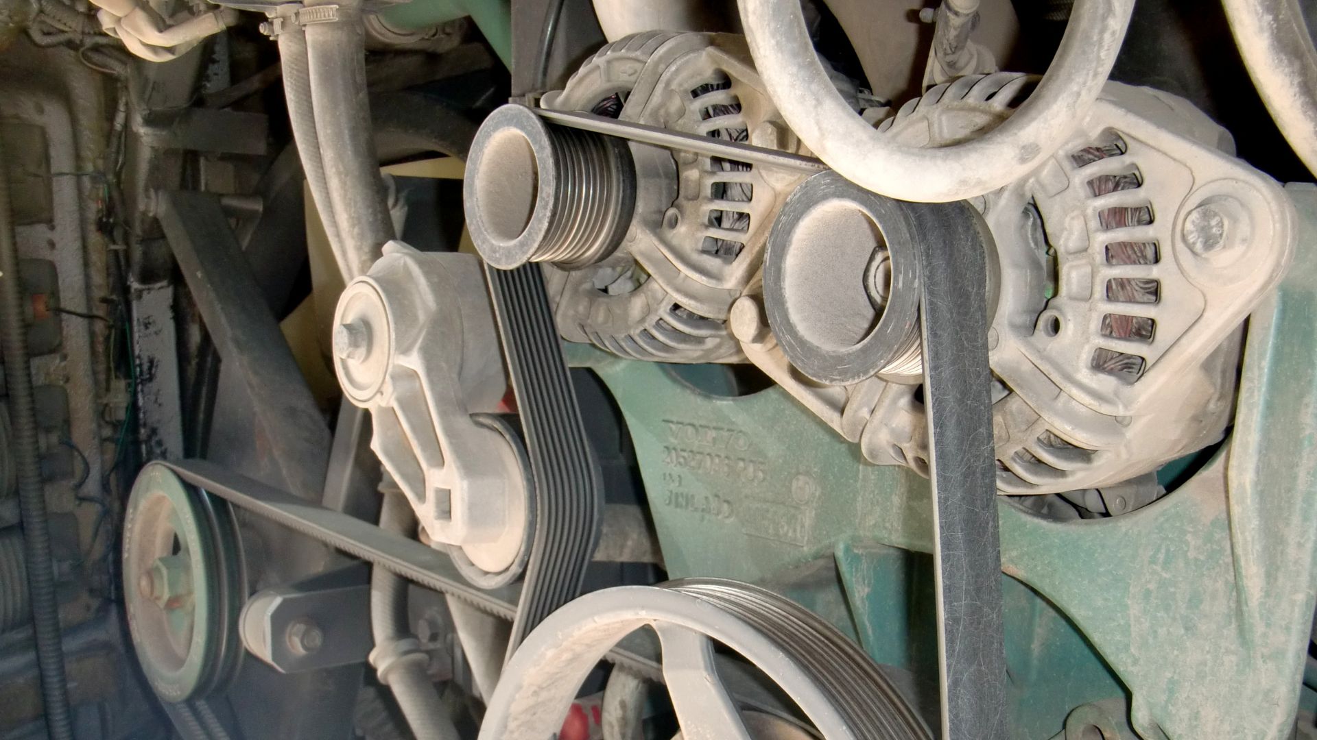 Belt drive system of VOLVO bus engine room. V-rib-belt(near) & Timing belt