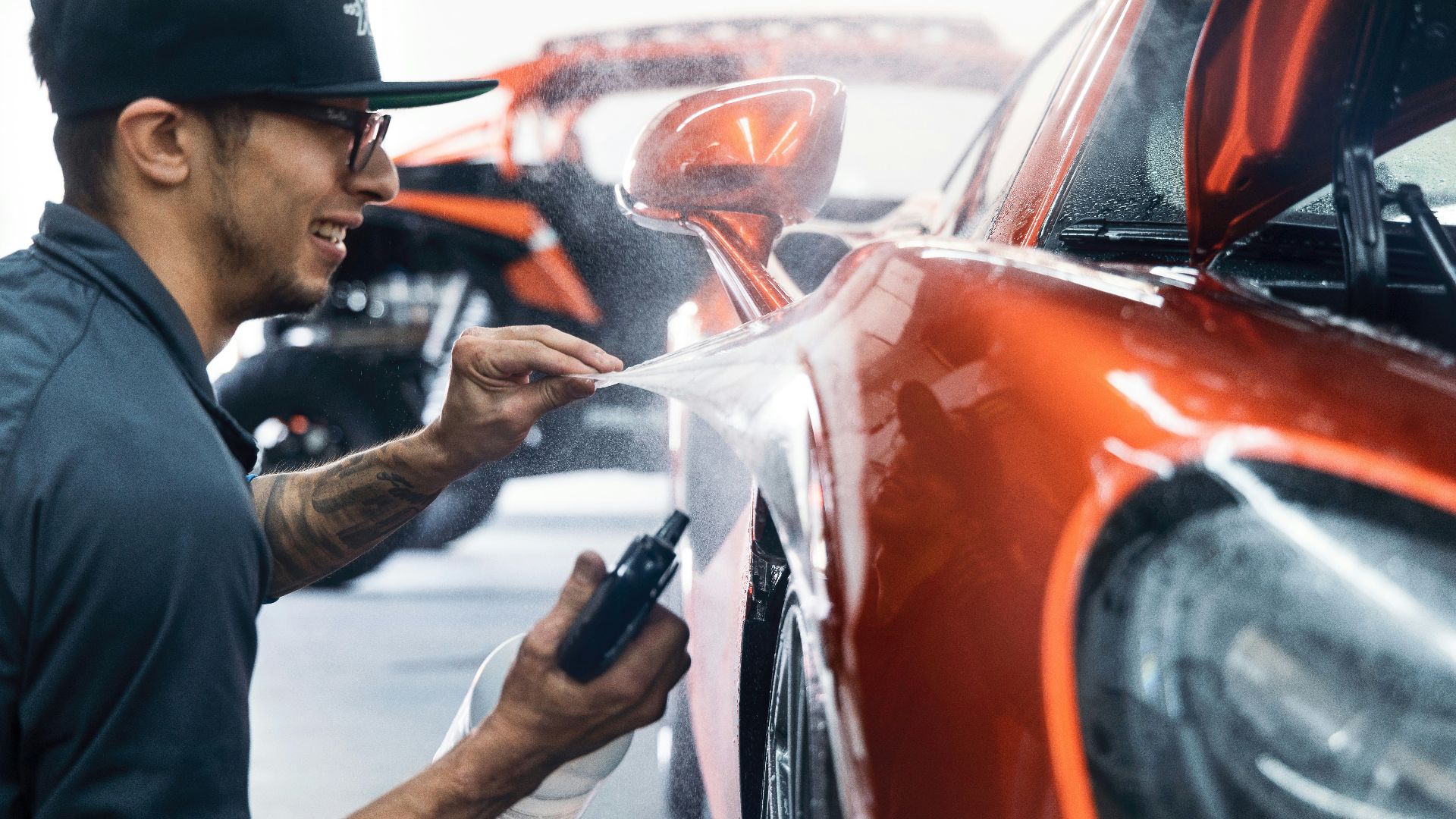 a man waxing a car in a garage