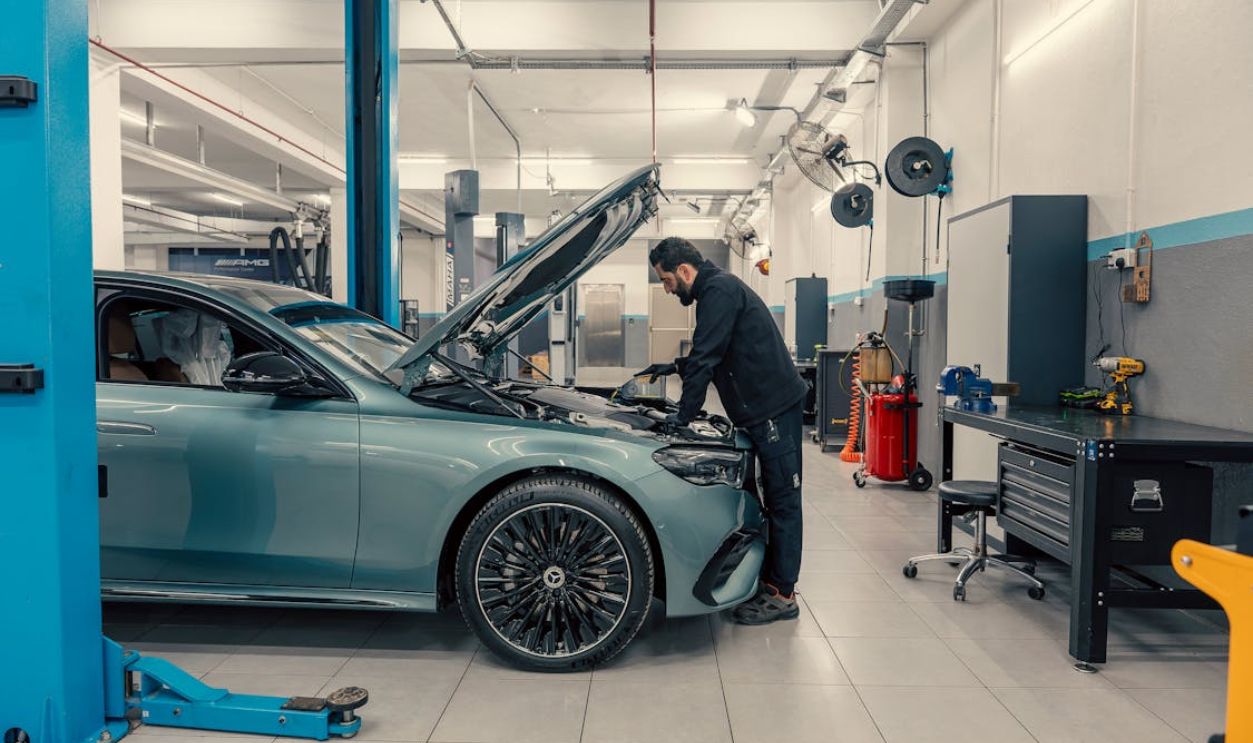 Mechanic Working on Luxury Car in Modern Garage