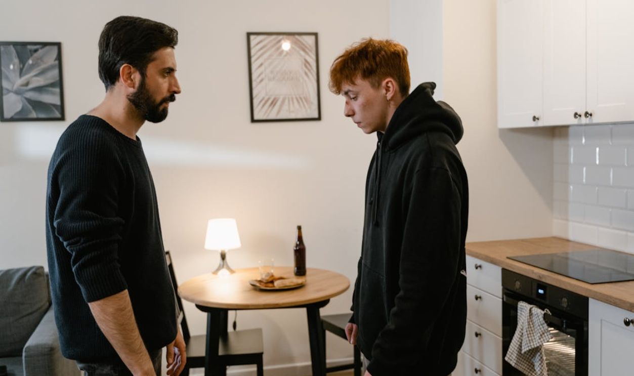 Bearded Man Looking at the Person in Black Hoodie Sweater