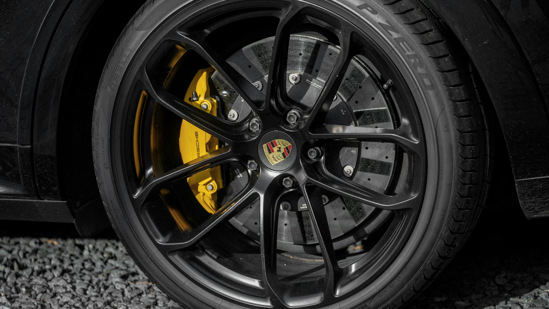 A close-up of a porsche car wheel.