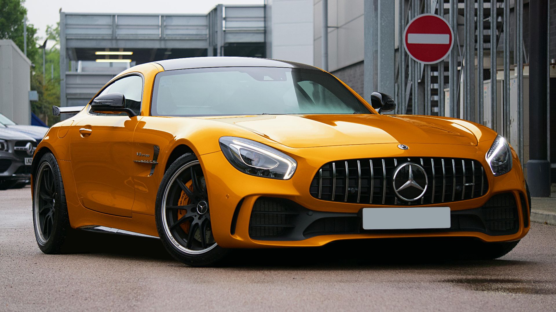 Gold luxury sports car parked on a UK street, showcasing sleek design and automotive elegance.