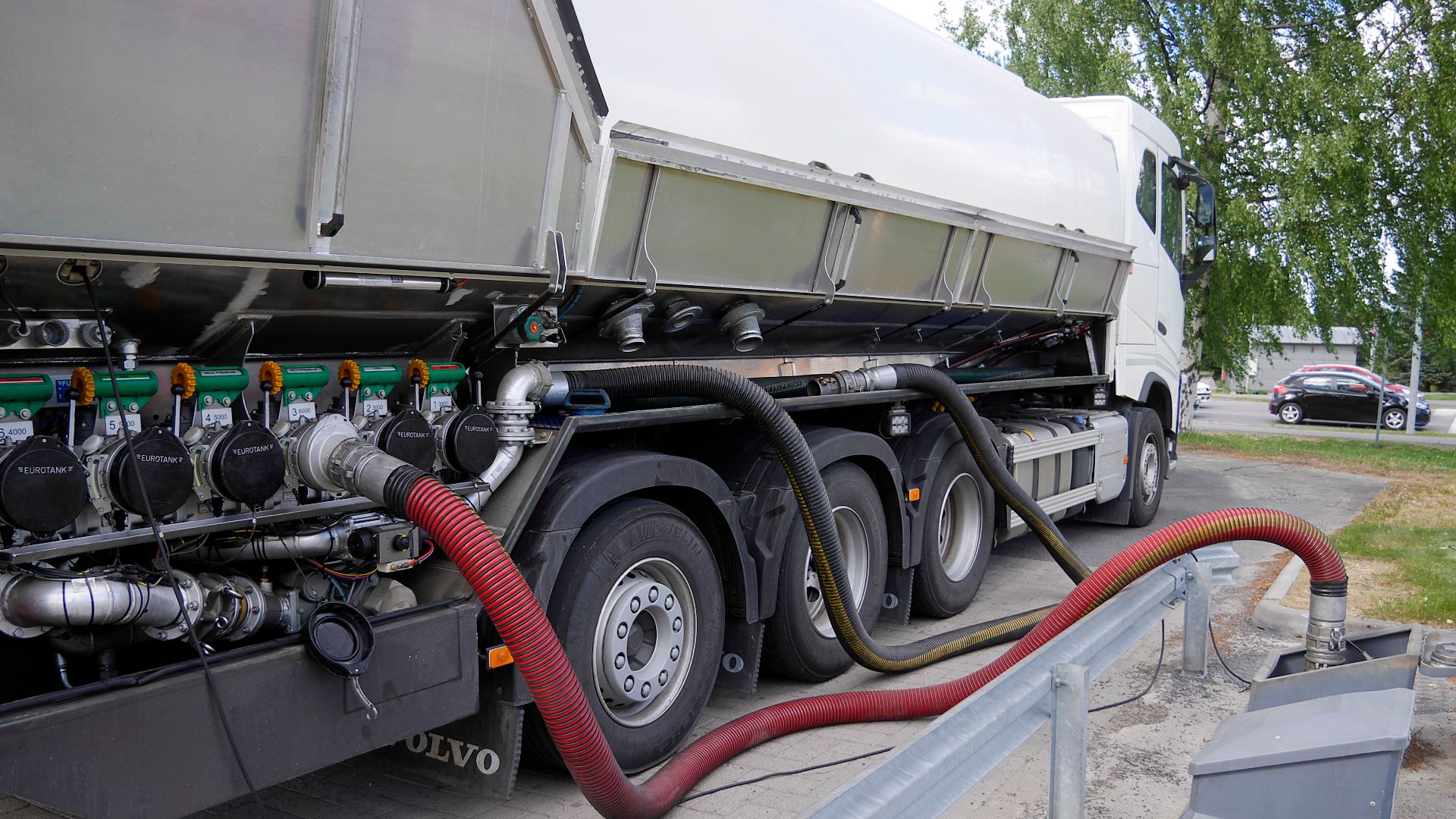 Fuel tank truck delievering fuel to petrol station.