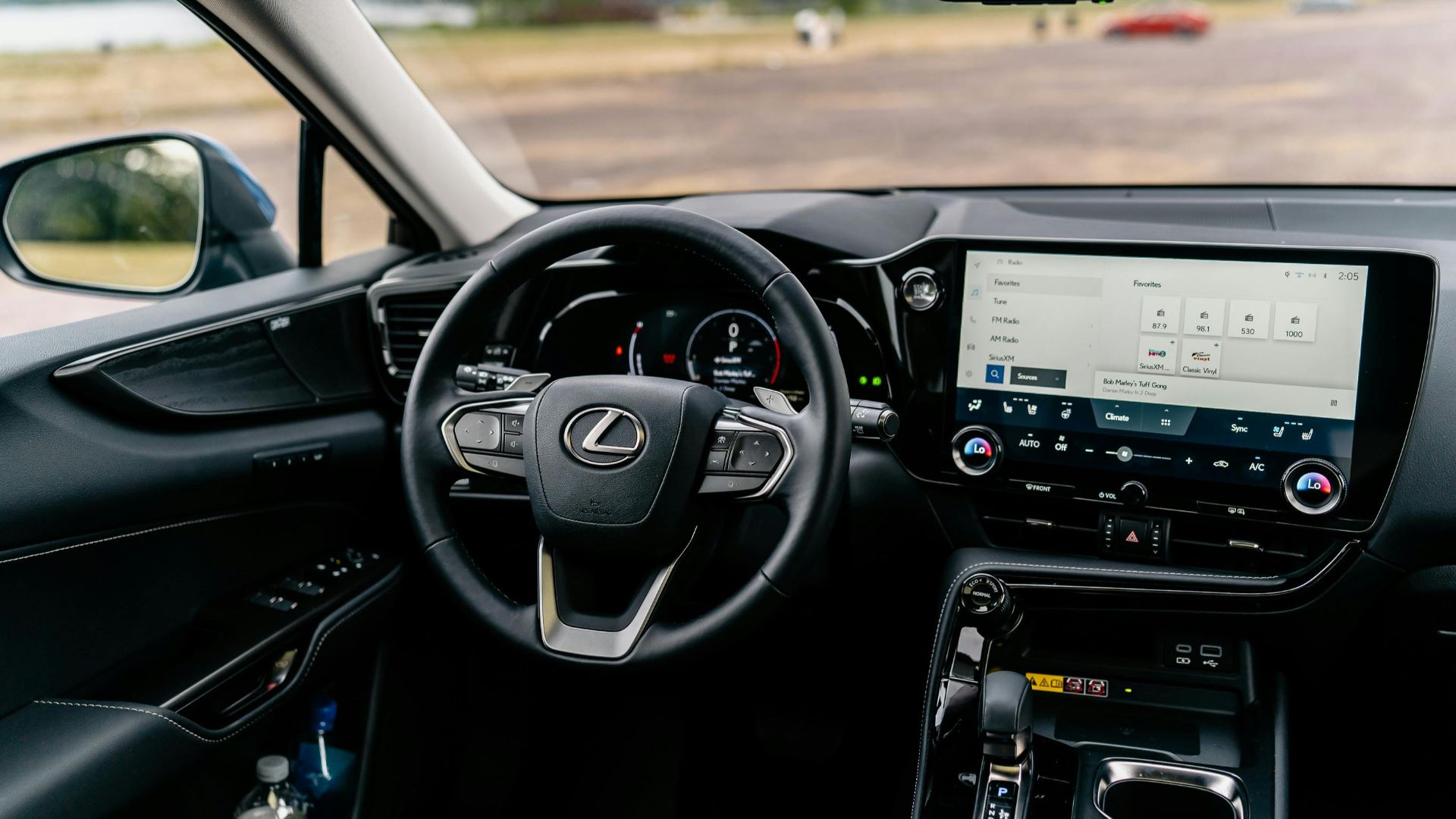 Detailed view of a Lexus car interior featuring a modern touchscreen and steering controls.