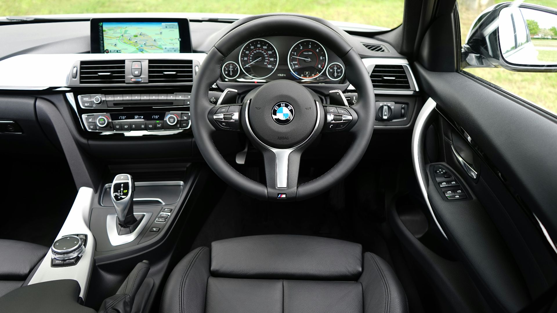 Explore the luxurious interior of a BMW car featuring a modern dashboard and navigation system.