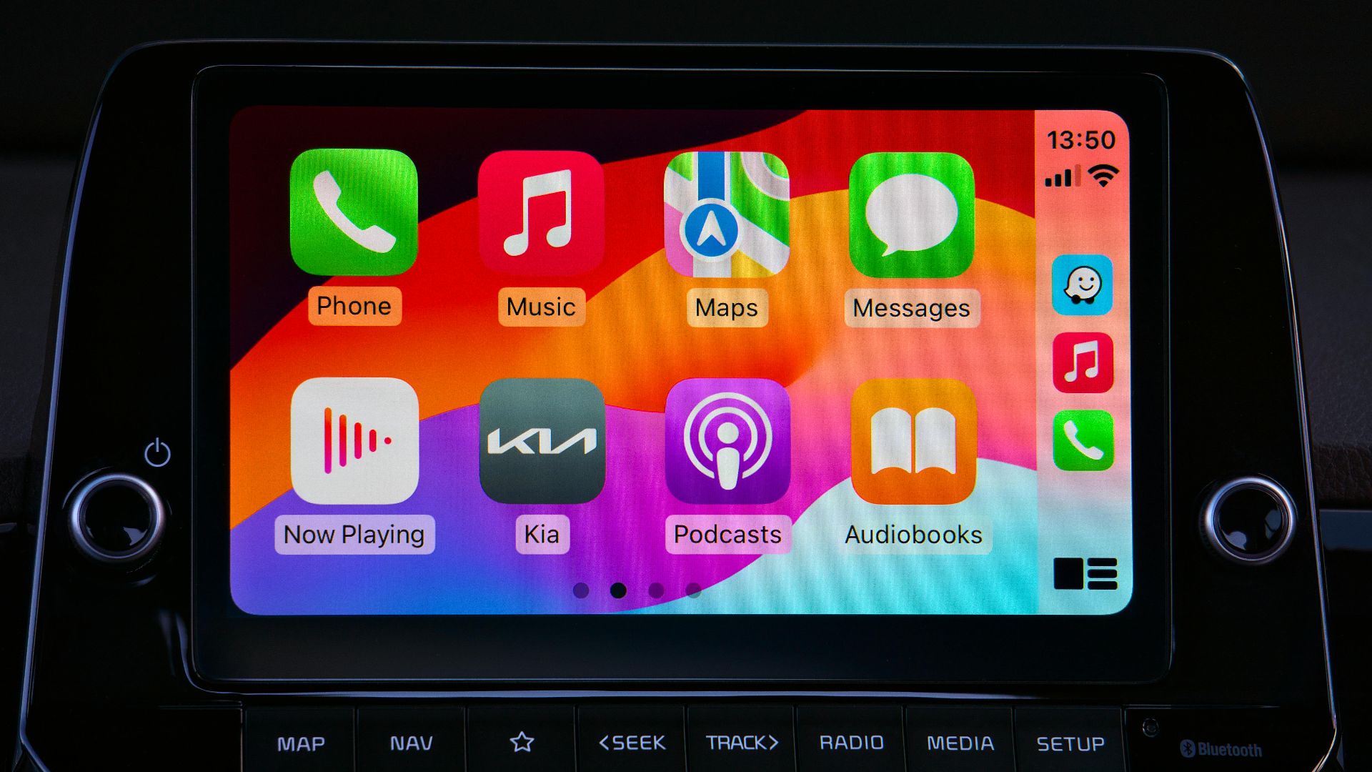 Close-up of a car's modern touchscreen display showcasing various app icons for enhanced in-car connectivity.