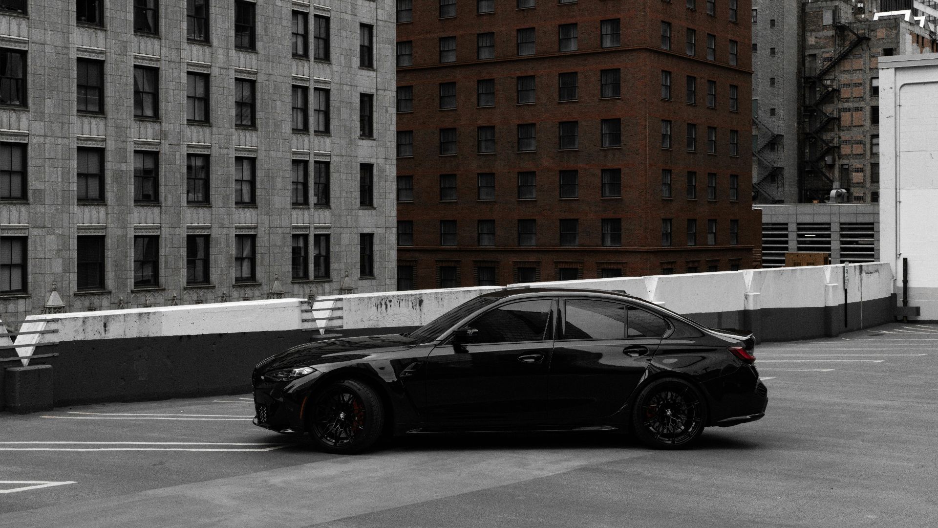 A stylish black car parked on a rooftop amid Chicago's urban backdrop.
