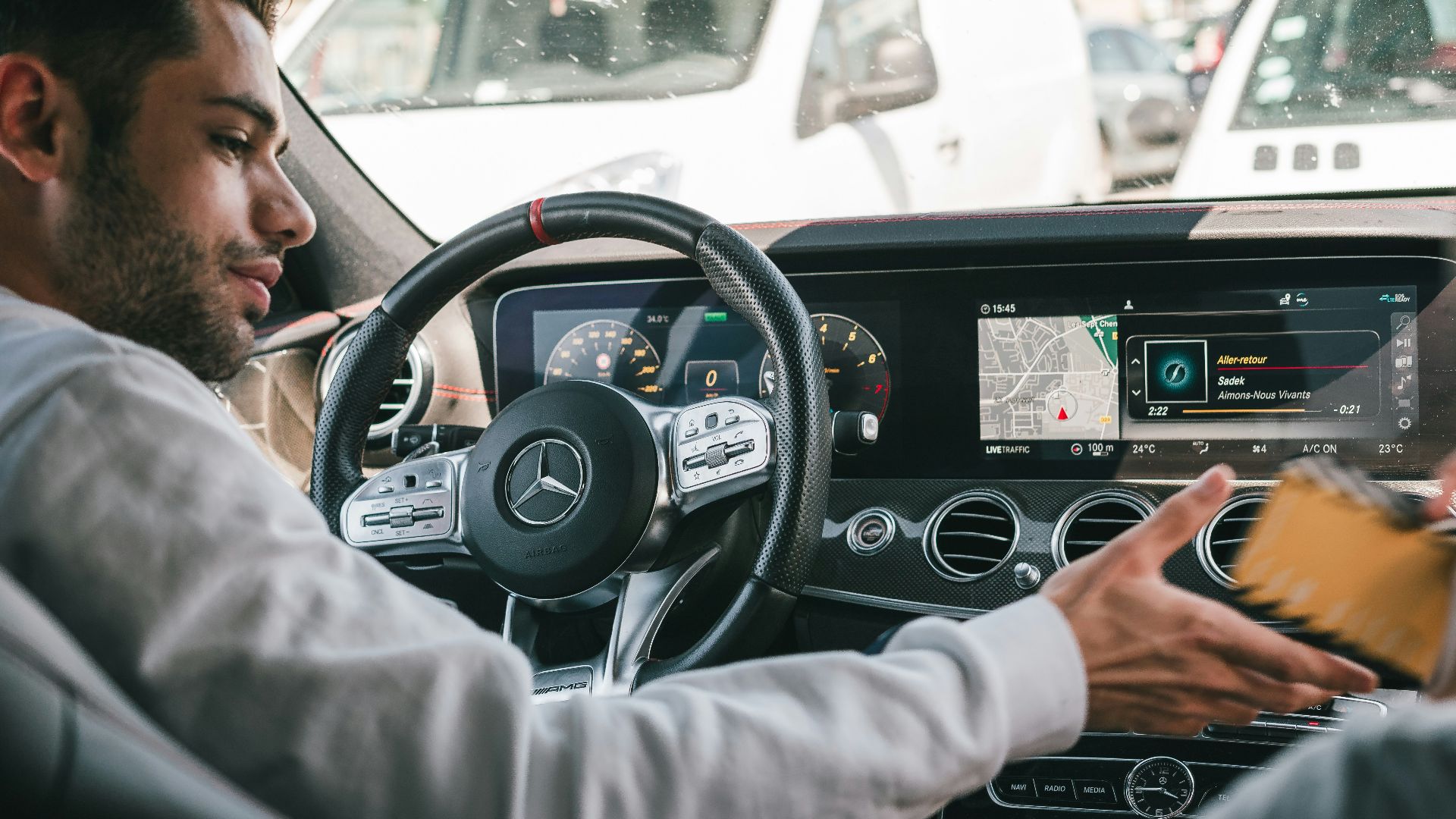 man in gray sweater driving car