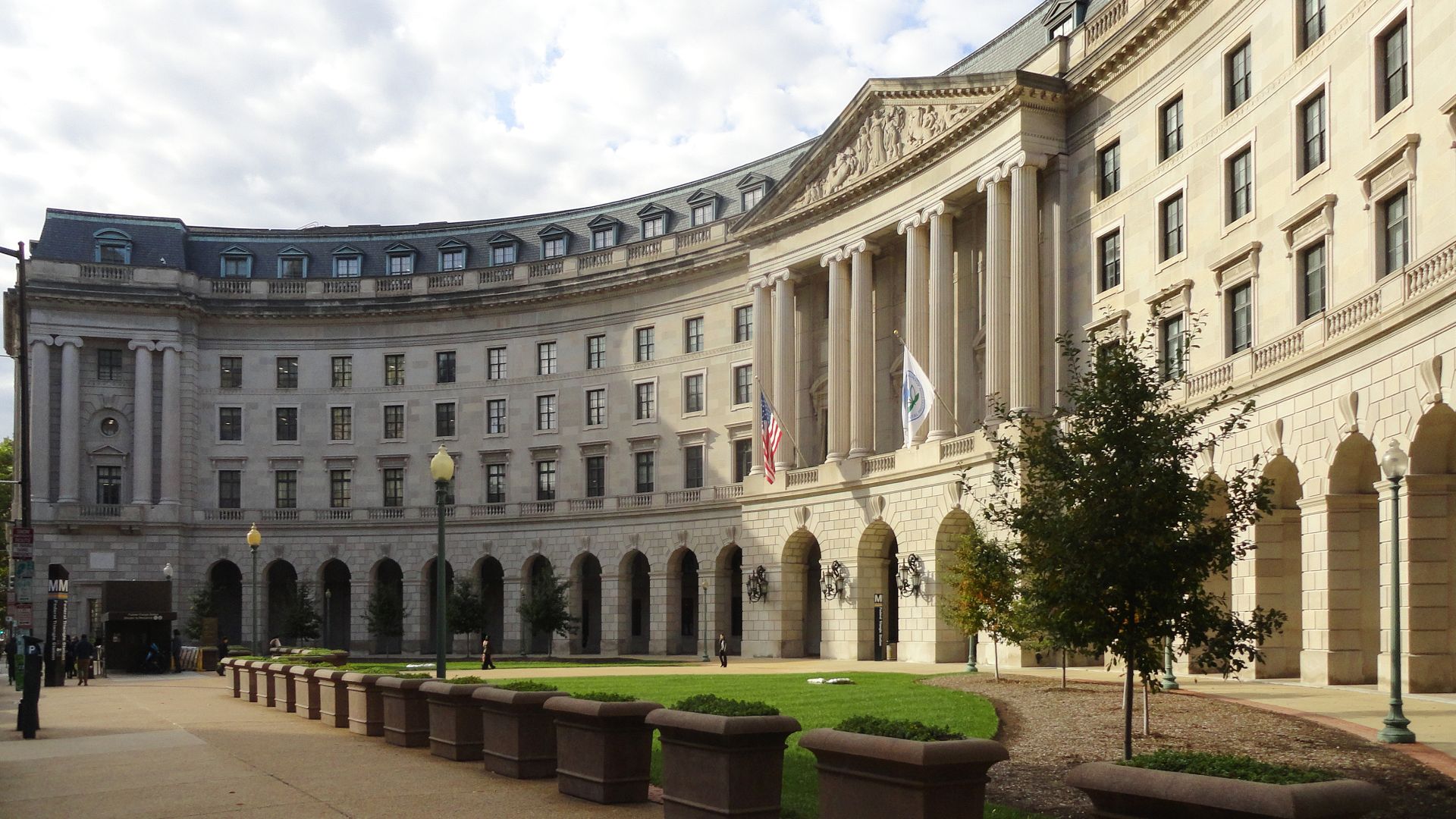 Main entrance of U.S. EPA Headquarters; the William Jefferson Clinton Federal Building on 12th Street, N.W., Washington, D.C. The pylon and elevator entrance for the Federal Triangle Metro station is seen on the left.