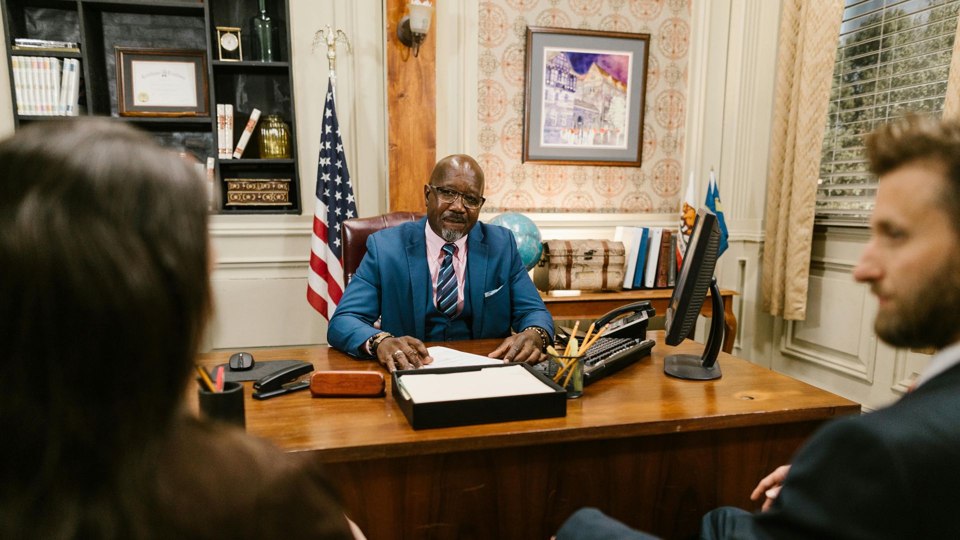 A professional lawyer meeting with clients in his office at a legal consultation.
