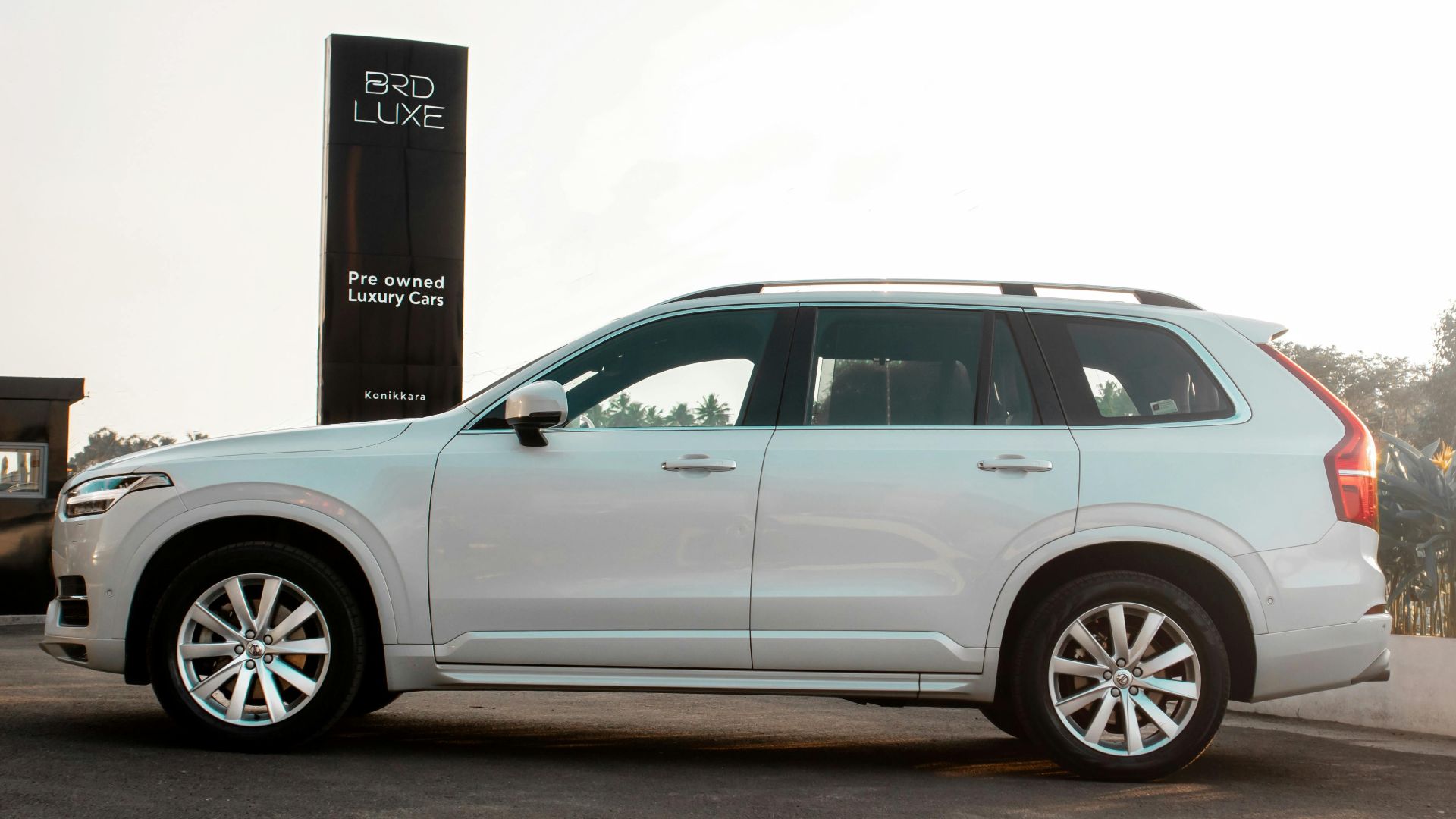 Side view of a luxury white SUV showcased at BRD Luxe pre-owned cars. Elegant and modern design.