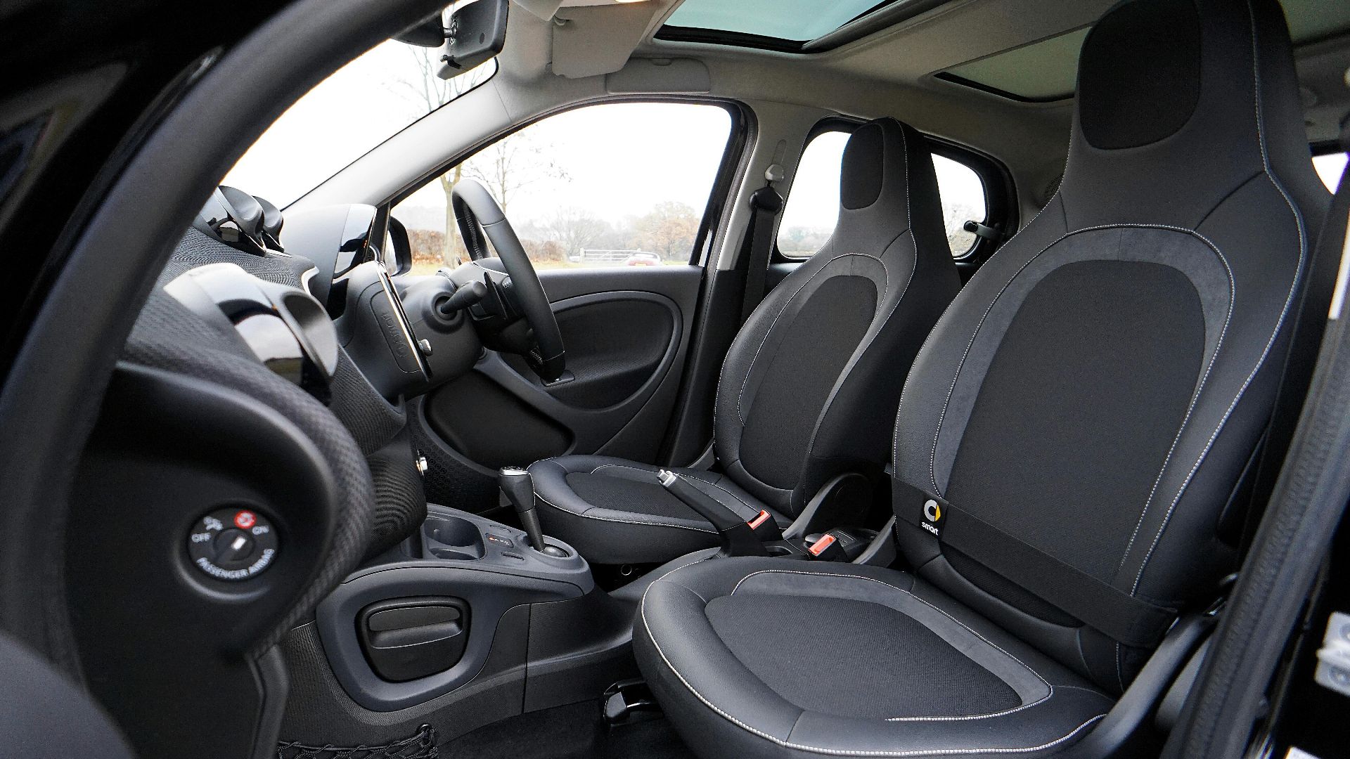 Explore the sleek interior of a modern luxury car featuring leather seats and advanced technology.