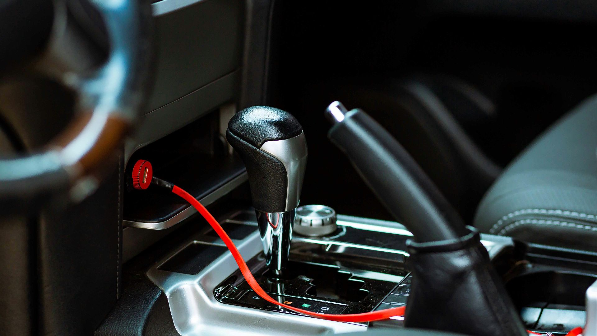 Close-up of a car's gearshift and handbrake highlighting the modern vehicle interior.