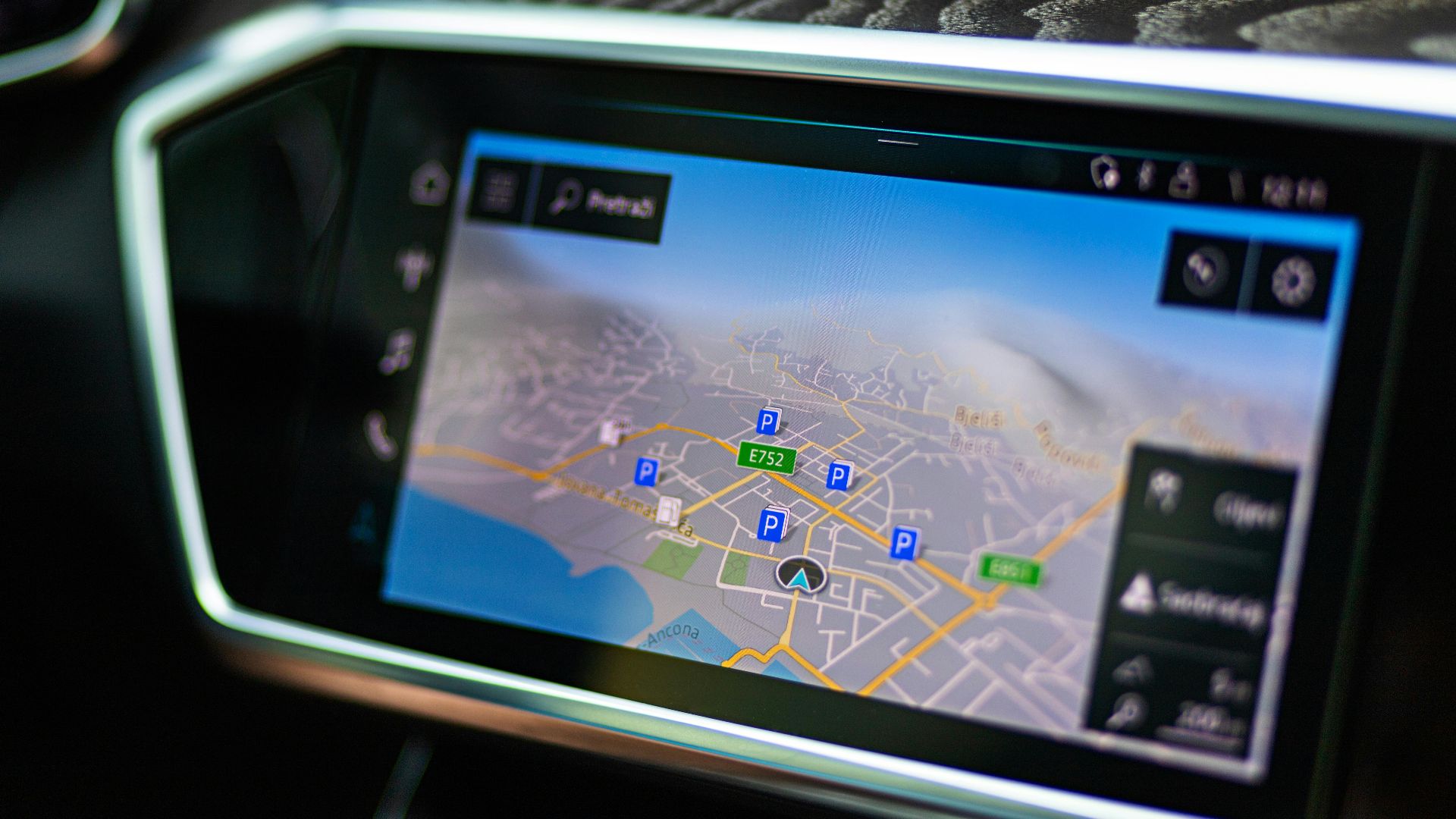 Close-up of a car's touchscreen displaying GPS navigation in a modern vehicle interior.