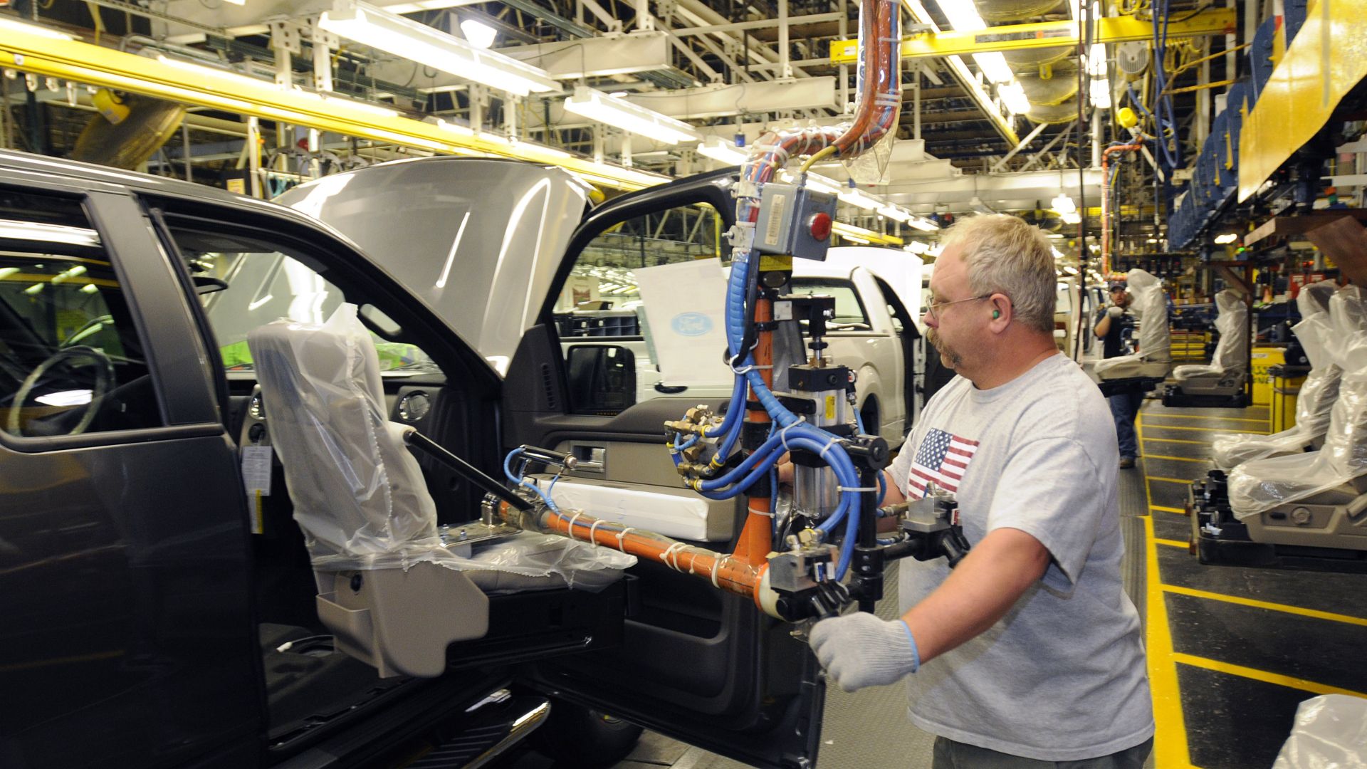 A worker installs a seat into a Ford F-150 at the w:Ford Kansas City Assembly Plant, Claycomo, Missouri, USA.