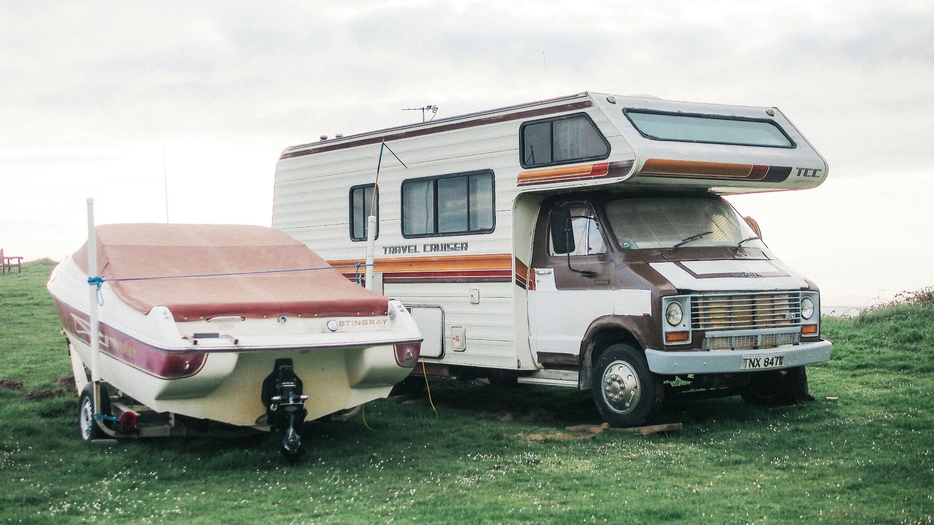 a motor home is parked next to a trailer