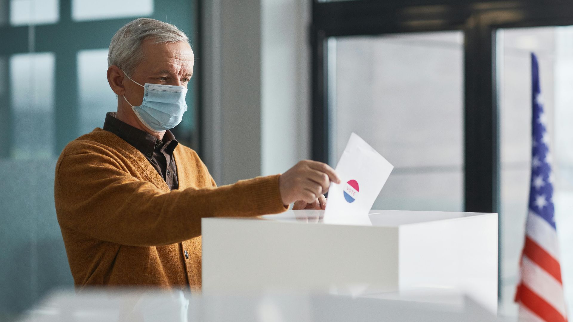 Concerned brunette woman in a green shirt working on a laptop inside an RV.