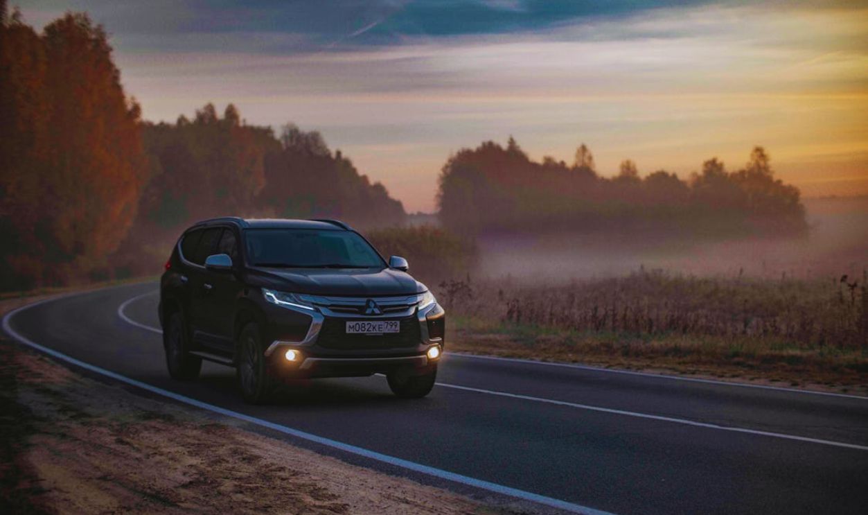 Modern offroad car driving along countryside road