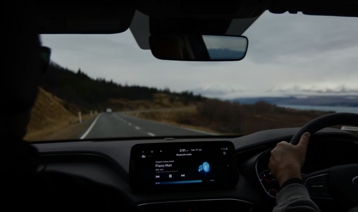 person driving car on road during daytime