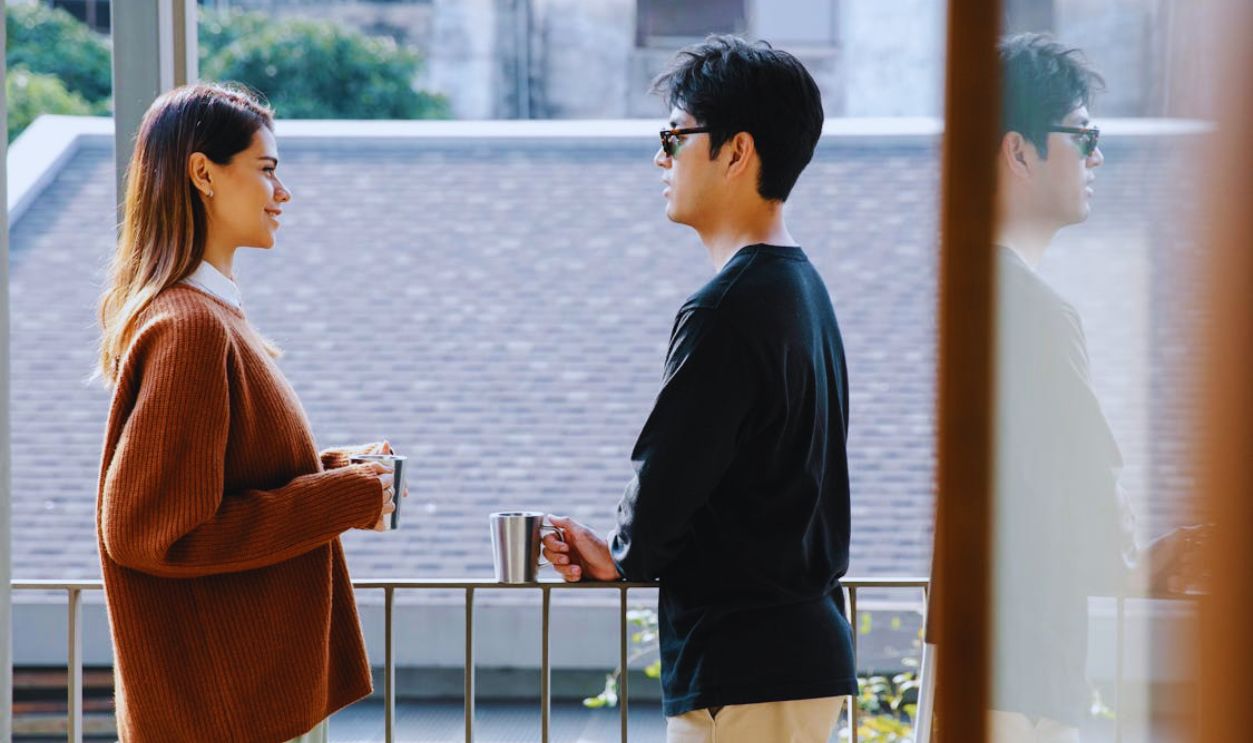 Photo of Man and Woman Chilling in the Balcony
