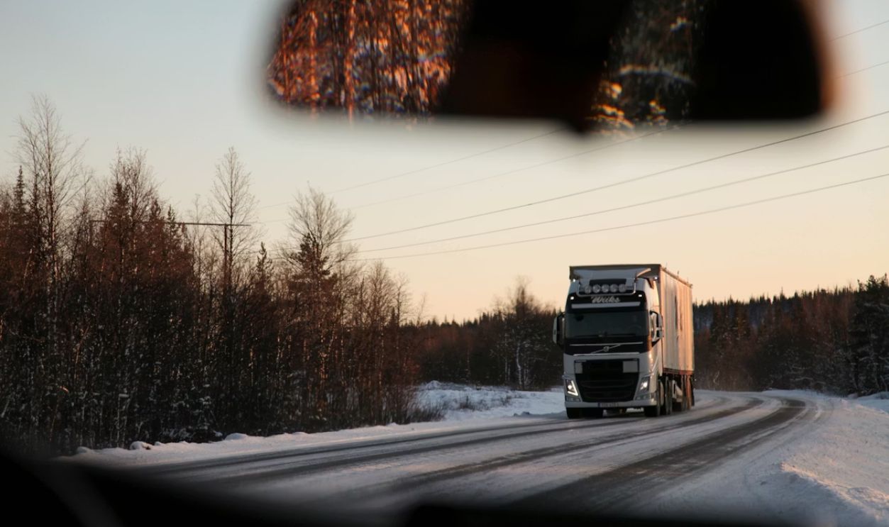 gray cargo truck on road during daytime Driving in Sweden during winter