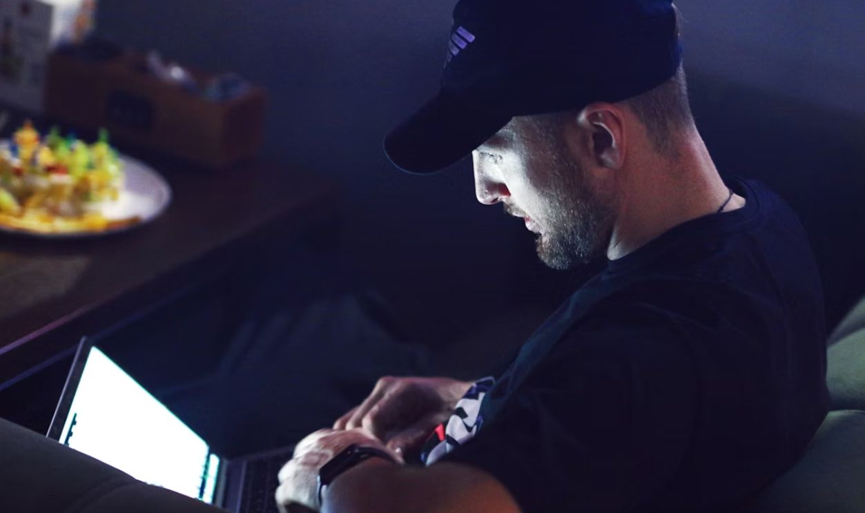 a man sitting in front of a computer Doing business
