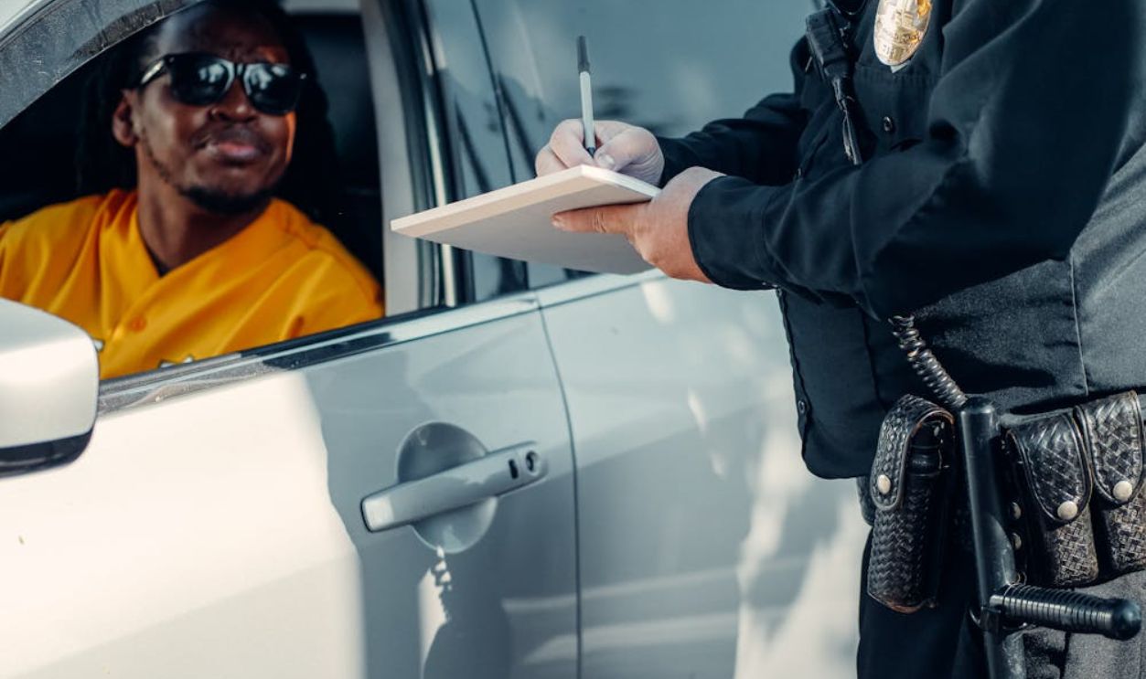 Man Looking at the Police Officer Writing