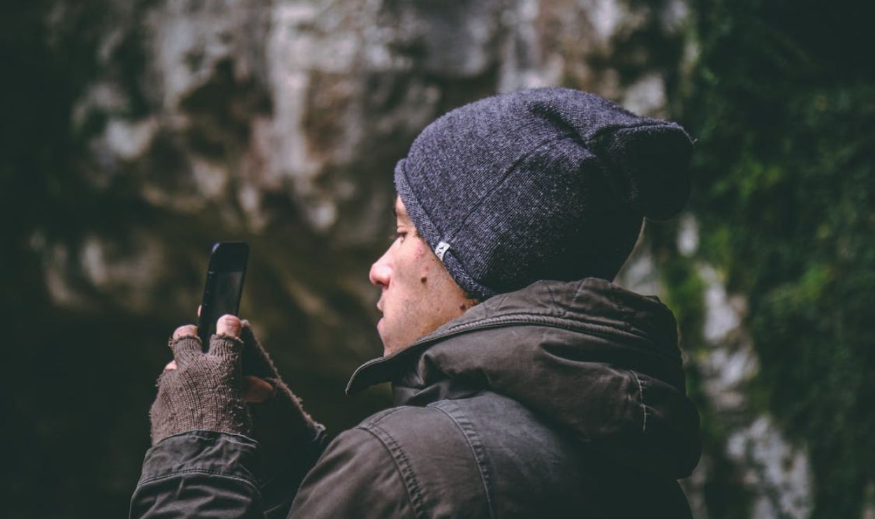 Man Wearing Beanie Holding Smartphone