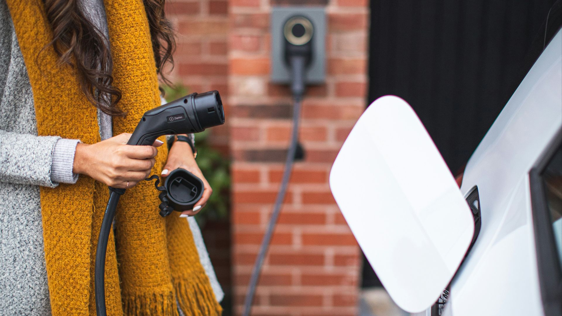 a woman is pumping gas into her car