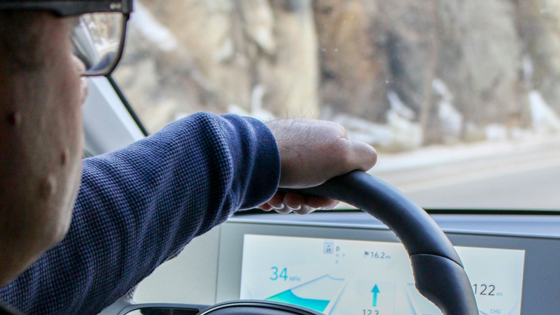 a man driving a car on a snowy road