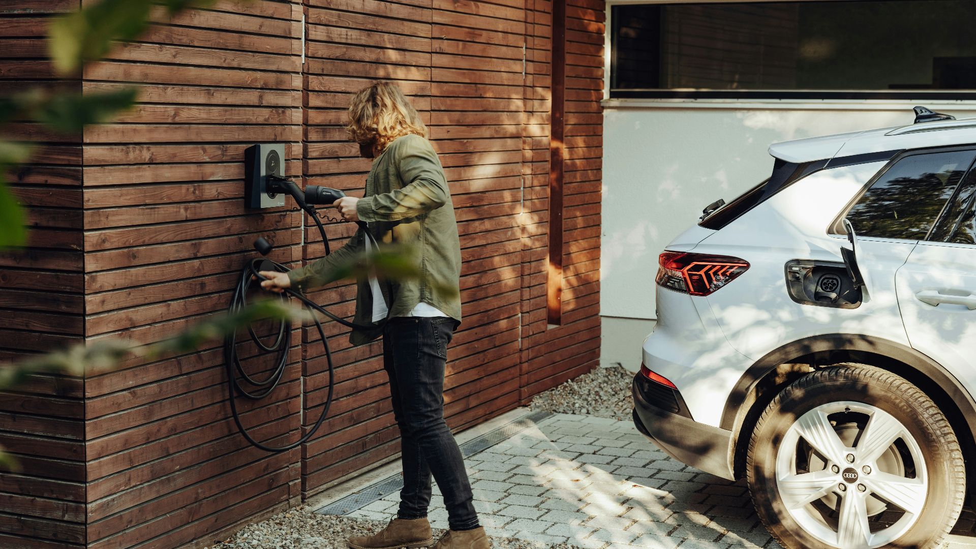 a woman is using a power washer on a brick wall