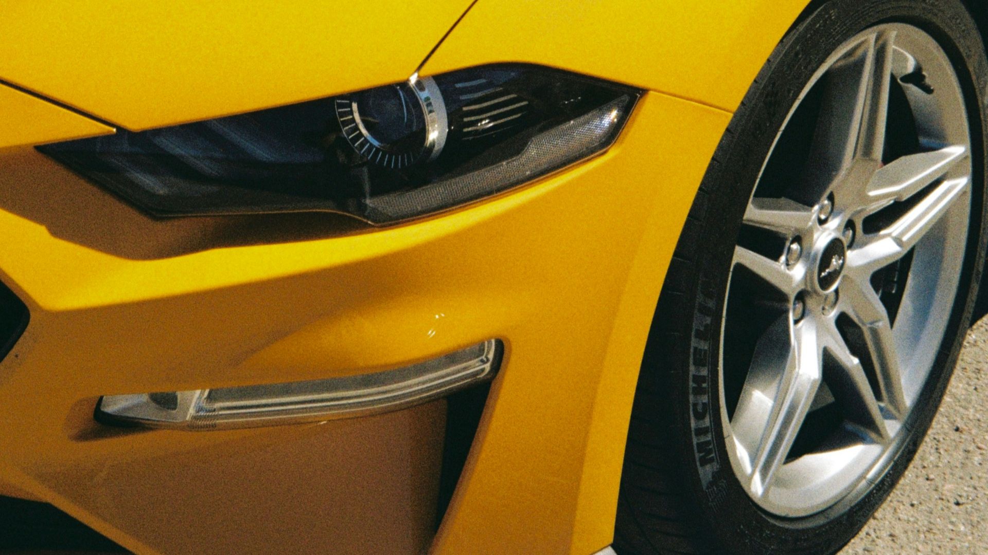 the front of a yellow car