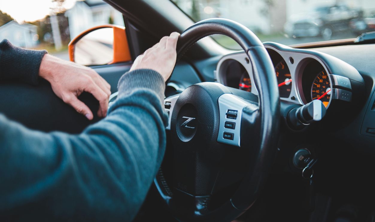 Man driving expensive luxury car in comfortable interior